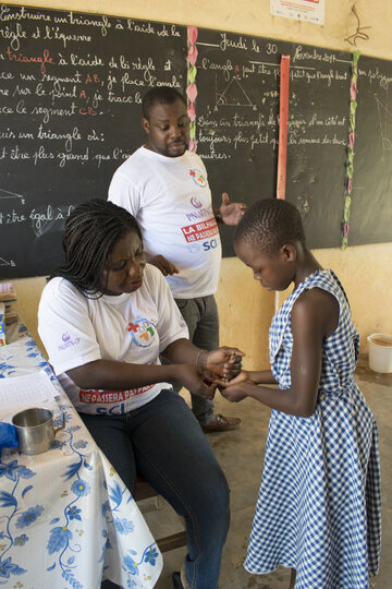 Child receiving treatment. Image copyright Schistosomiasis Control Initiative