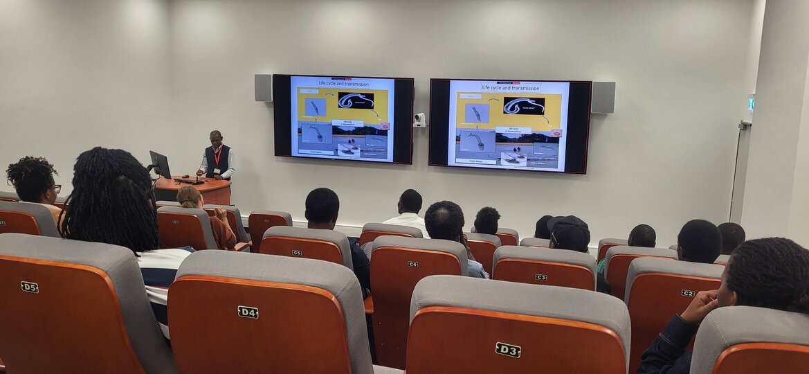 Dr. Shaali making a public lecture at Malawi Liverpool Wellcome Research Programme amidst Researchers